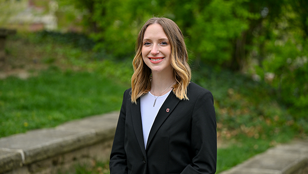 Individual standing outside smiling