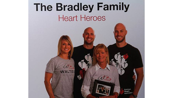 Four individuals together for a photo with the text 'The Bradley Family Heart Heroes' above them