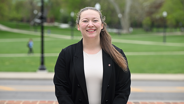 Individual standing outside smiling