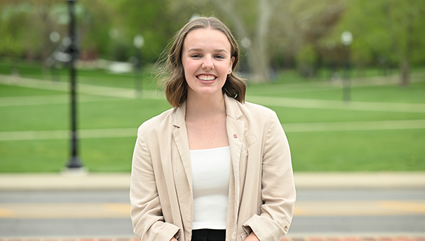 Individual standing outside smiling