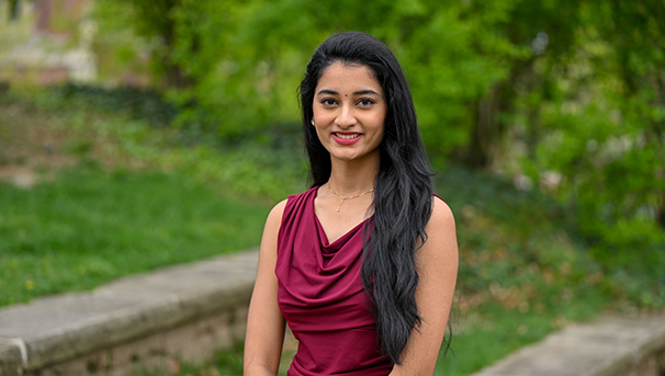 Individual standing outside smiling