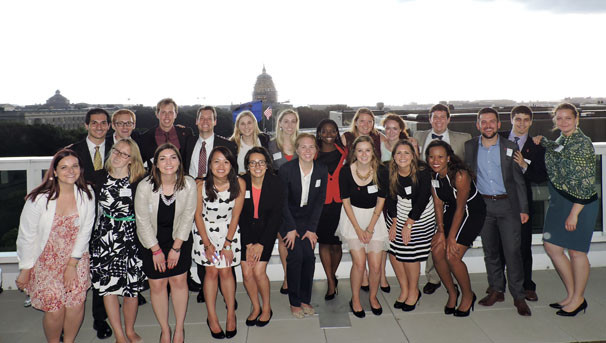 Group of students and faculty in business attire pose for picture in Washington DC
