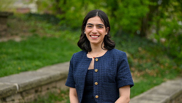 Individual standing outside smiling