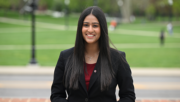 Individual standing outside smiling