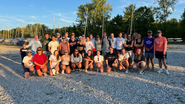 Group of individuals standing together for a photo outside