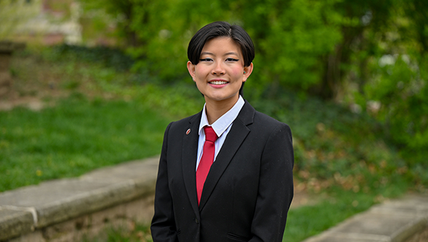 Individual standing outside smiling