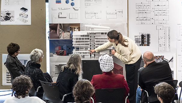 People watching a woman give a presentation