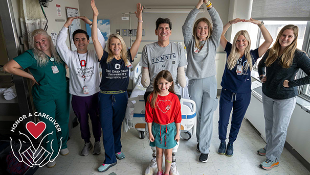 Patient with their caregiving team of six individuals and young kid standing in front