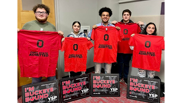 Five students holding Ohio State admitted t-shirts and I'm Buckeye Bound posters