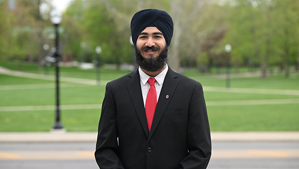 Individual standing outside smiling