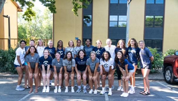 Volleyball team taking a team picture.