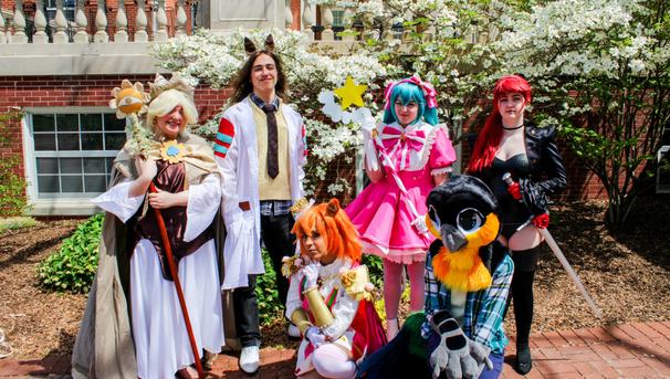 Group of six students posing in their cosplay outfits