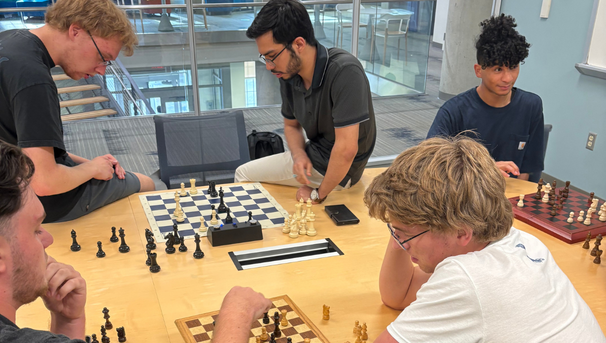 Group of students playing chess in an HCC study room