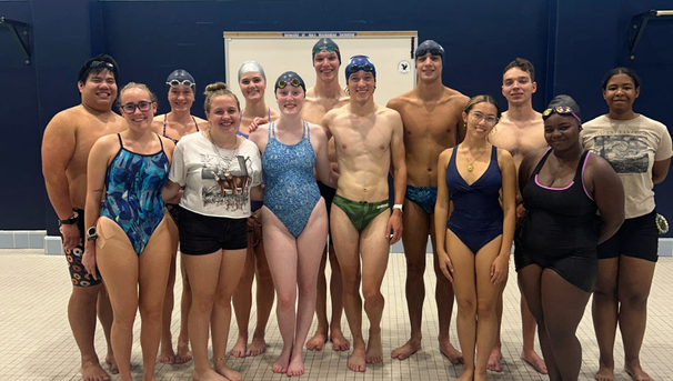 Group of students in swim suits on the pool deck
