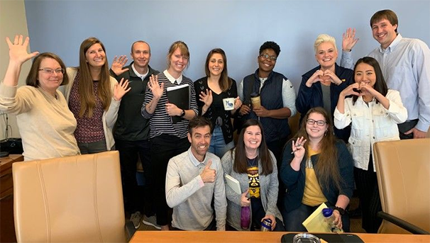 Group photo of various Carruth Center clinicians waving, heart hands, and thumbs up.