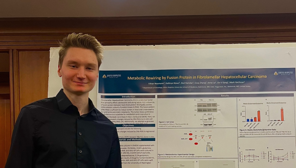 Ethan Neumann smiling with his research