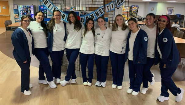 10 MUPNA members posing for a photo in scrubs