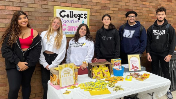 Members tabling and offering informational pamphlets and snacks