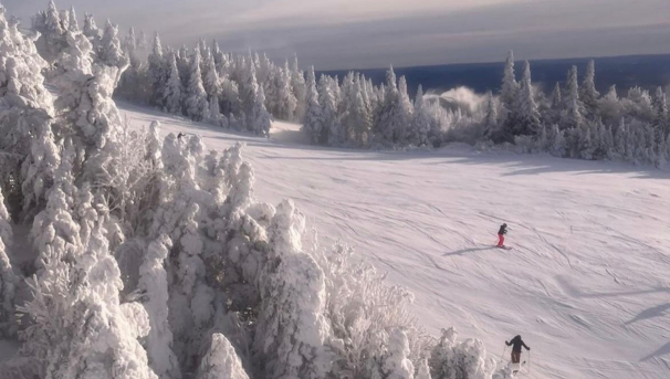 Scenic shot of a snow covered mountain taken from a ski lift