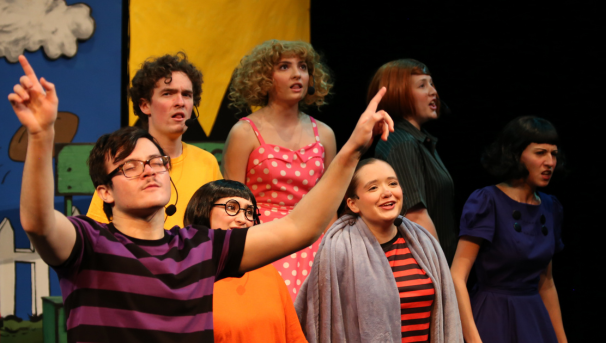 Costumed performers singing during a show