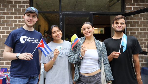 Four happy LASO members with flags