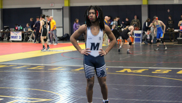 Wrestler in Monmouth gear preparing for a match