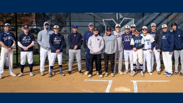 Current members with a group of alumni who came back for a game