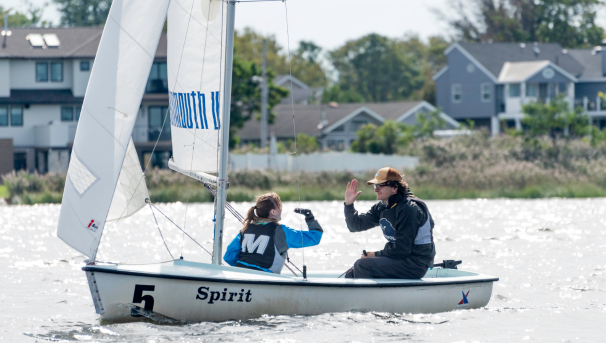 Monmouth sailors high fiving on the water