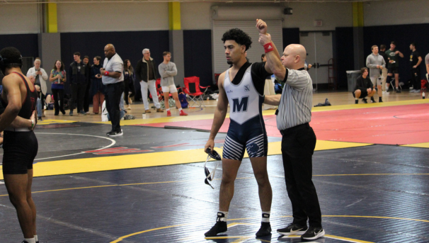 Monmouth wrestler with ref after winning a match