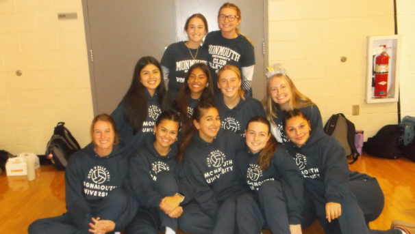 players posing for a group photo in matching volleyball sweatshirts