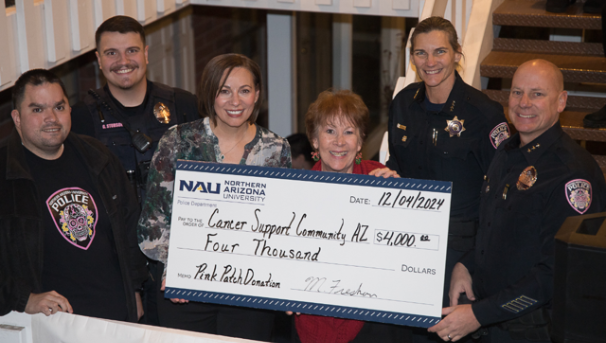 NAU PD presenting a check for $4,000 to the Cancer Support Center in December 2024