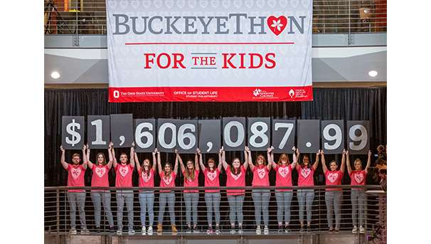 Students hold up the total amount raised for Buckeyethon: $1,606,087.99