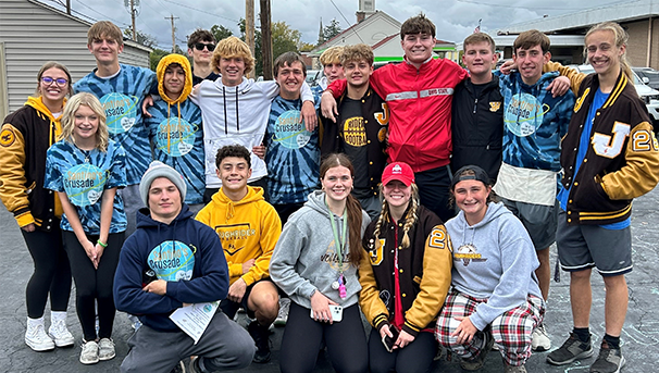 A group of young people wearing Santino's Crusade shirts