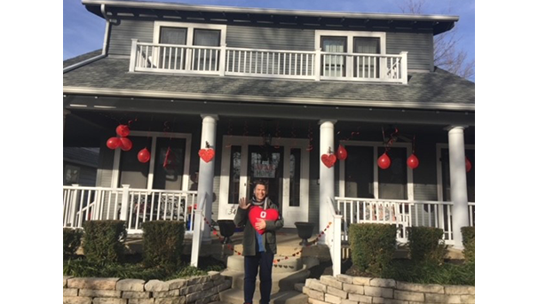 Dan Leite in front of a Valentine's Day decorated front porch