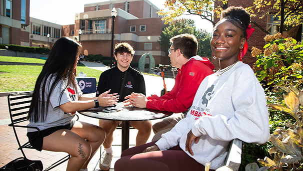 Students sitting at a table outside