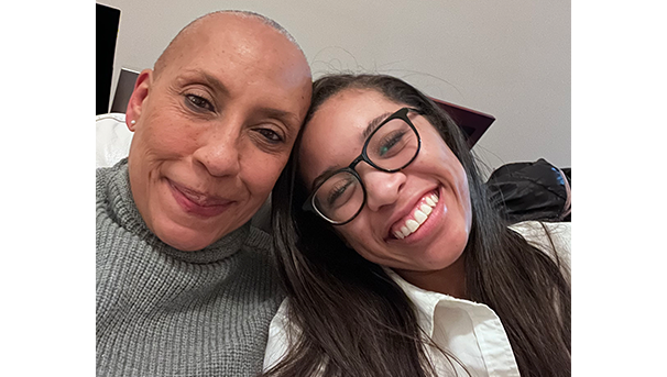 Two individuals taking a selfie while smiling