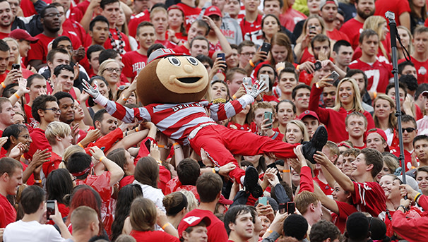 Brutus crowd surfing on students during an Ohio State football game.