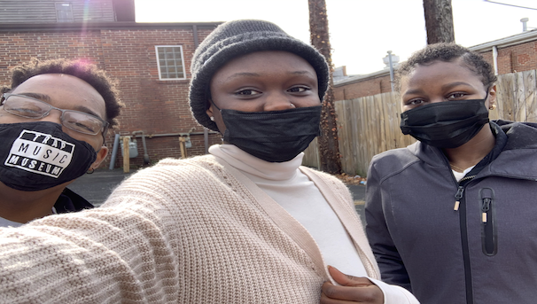Three people pose for a selfie. They are all wearing masks