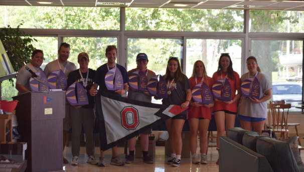 Group of individuals holding up their awards standing together for a photo