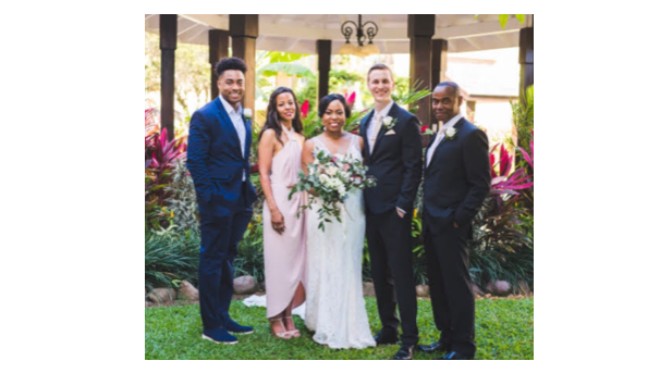 A wife, groom, and three family members stand together