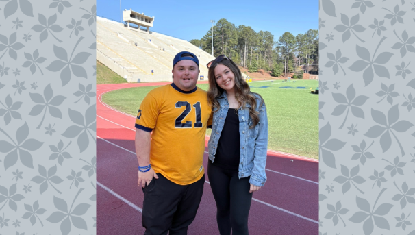 Taylor Schindley with student on an outdoor track