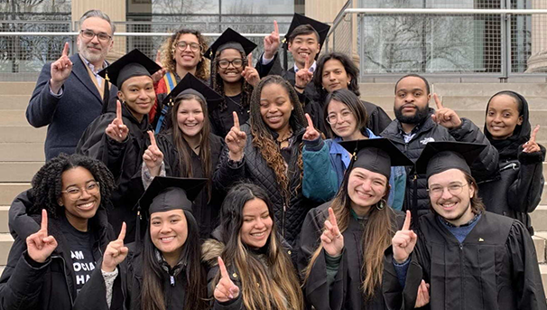 A table lined with wooden plaques. On them are golden sphinxs and gold name plates