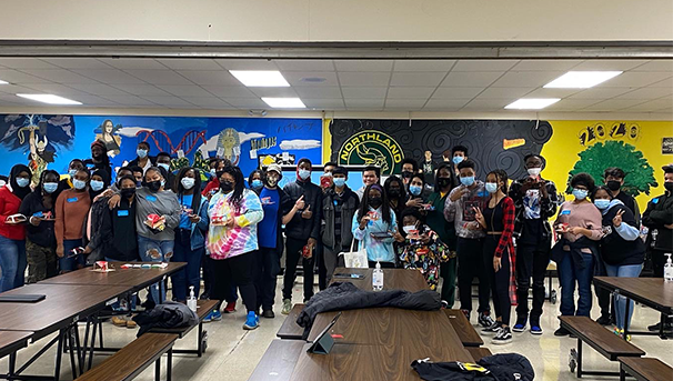 Group of students wearing masks in school while posing for a photo