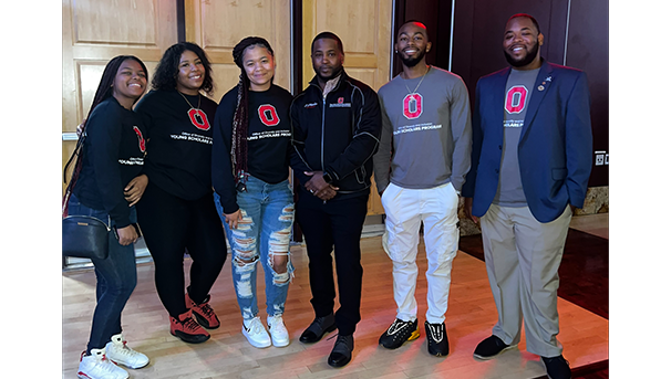 Six individuals standing in the Ohio Union smiling for a photo