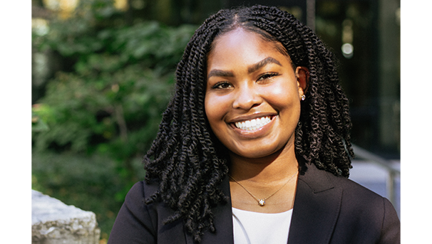 Individual smiling for a professional photo outside