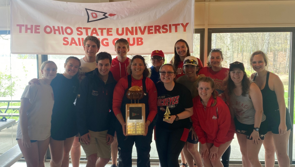 Group of Ohio State sailors smiling for a photo holding their trophy
