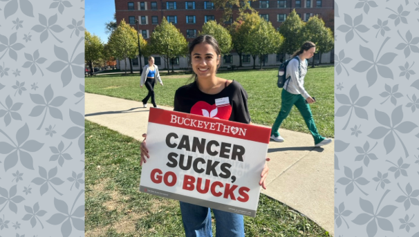 Ishpreet Devgan holding sign that says "Cancer Sucks, Go Bucks"