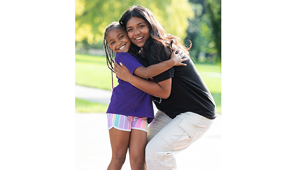 BuckeyeThon student hugging young champion kid outside