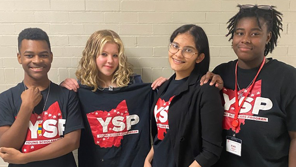 Four Youngstown students smiling for photo on their first day