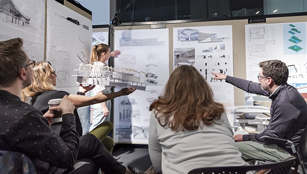 Students gathered around diagrams